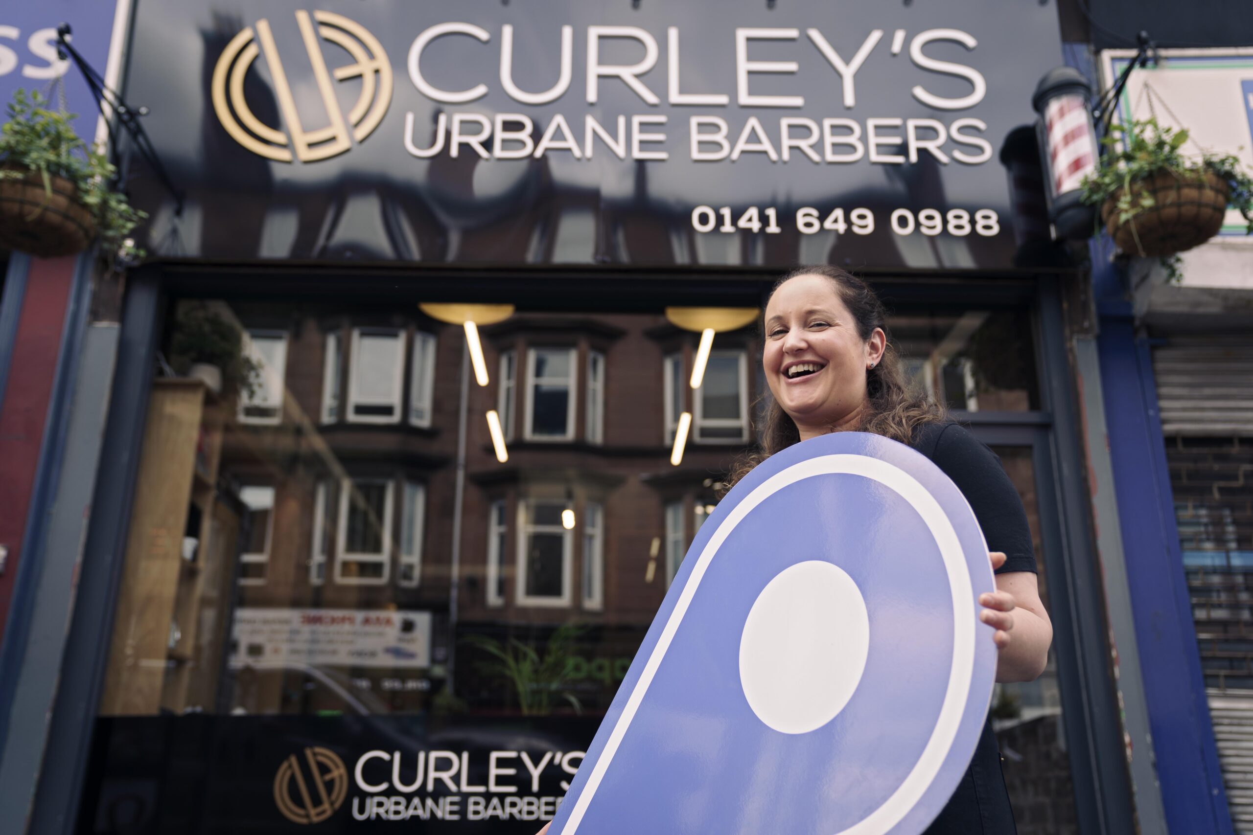 Free first use: Karina Curley, proprietor of Curley's Urbane Barbers (ALL CORRECT), on Minard Road, Shawlands, Glasgow. The business is one of several in Shawlands promoting the Scotland Loves Local campaign, encouraging people to choose local and back businesses in their community as part of the national recovery from the Covid-19 pandemic. The campaign is spearheaded by Scotland's Towns Partnership.Media enquiries to Chris Story on 07375 065 728 / chris@messagematters.co.uk